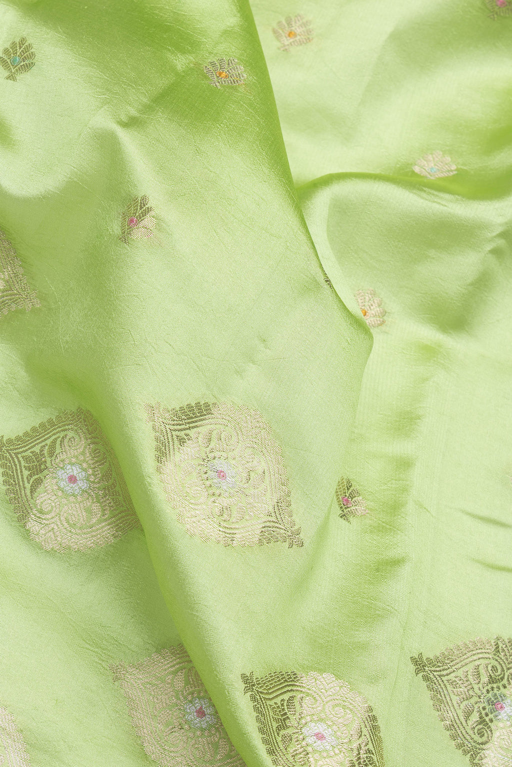 Close up of Parrot Green Dual Tone Tussar Silk Saree with Zari Butta on the body and Fancy Border.  displaying folds