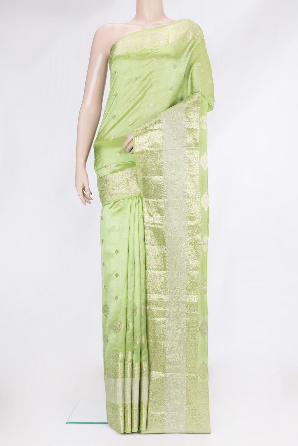 Parrot Green Dual Tone Tussar Silk Saree with Zari Butta on the body and Fancy Border.  displayed on a mannequin