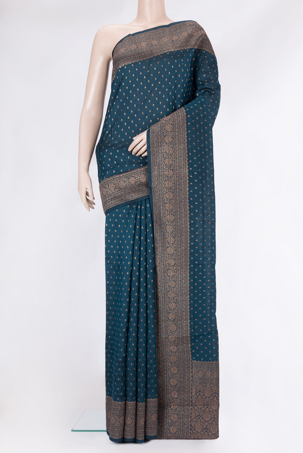 Peacock Blue Tussar Silk Saree with Zari Butta on the body and Zari Border.  displayed on a mannequin