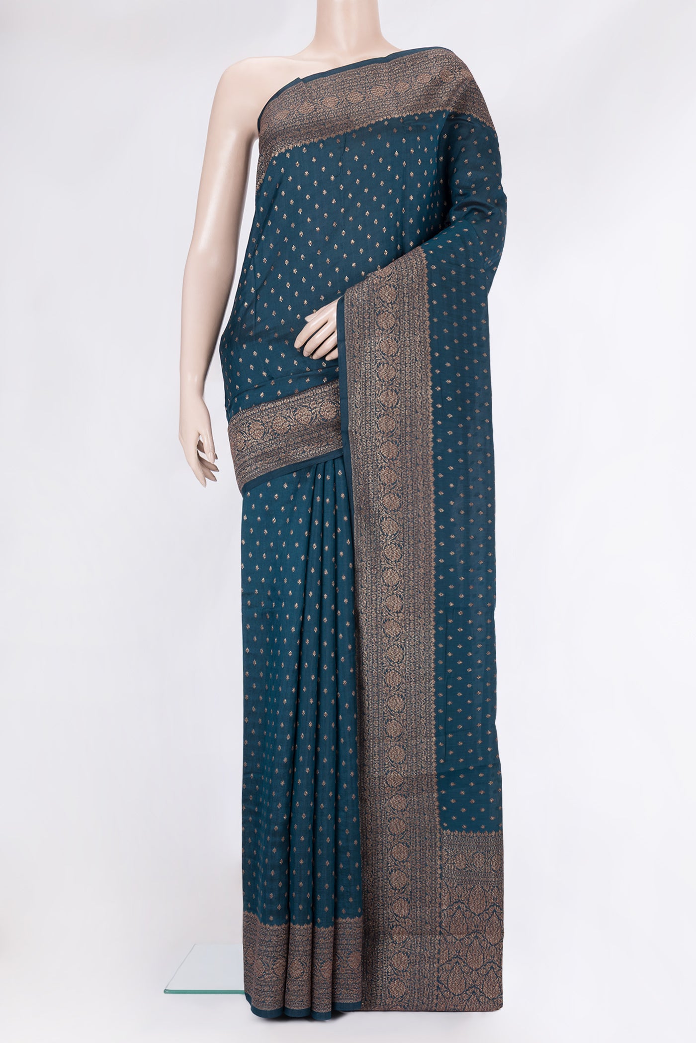 Peacock Blue Tussar Silk Saree with Zari Butta on the body and Zari Border.  displayed on a mannequin