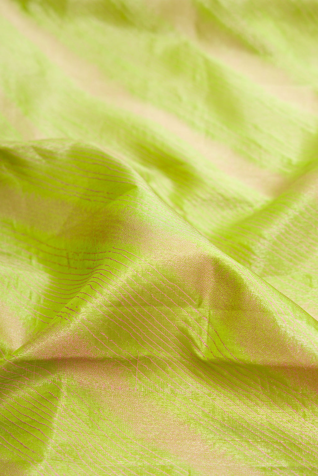 Close up of Parrot Green Dual Tone Kanjivaram Silk Saree with Stripes on the body and Fancy Border.  displaying folds