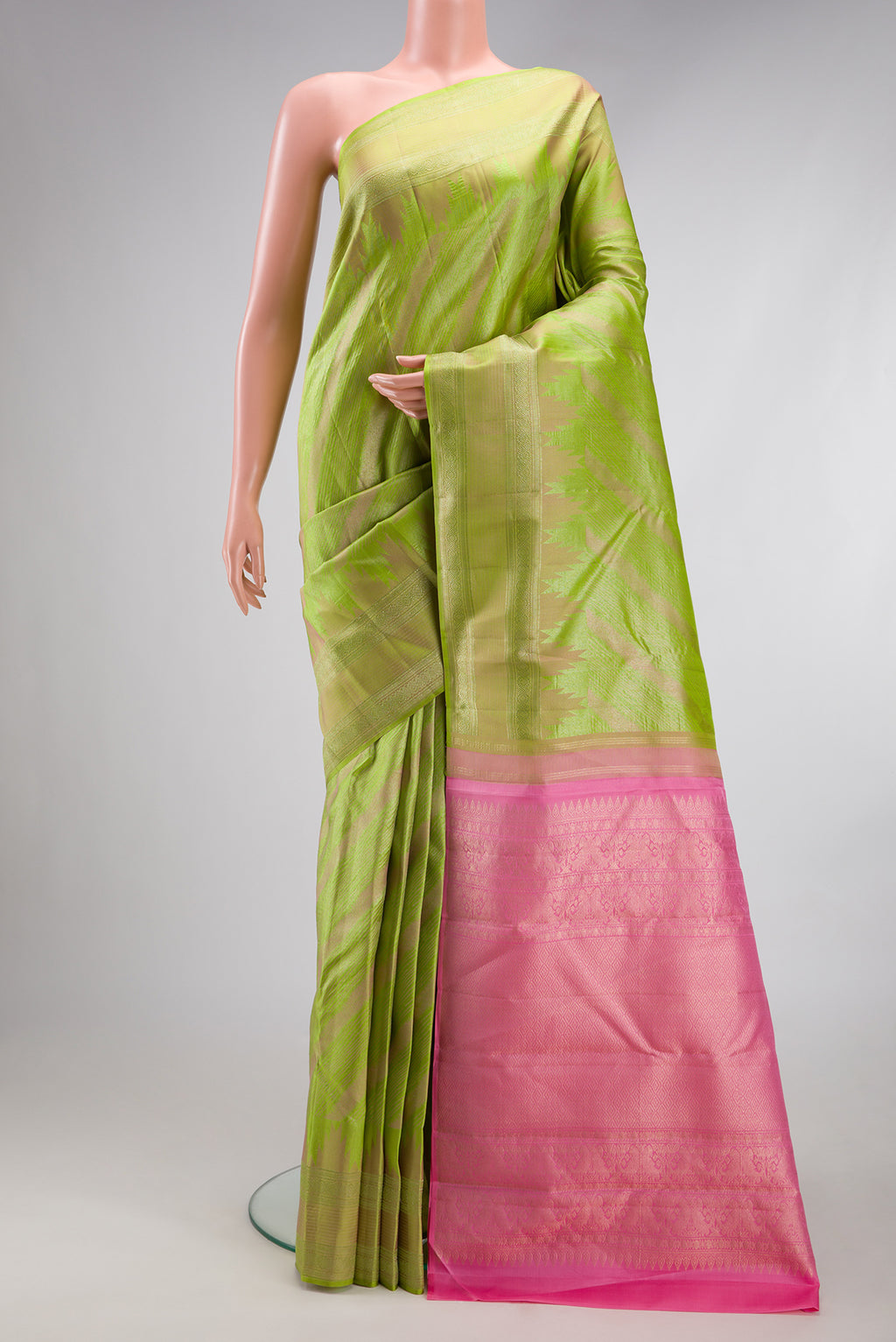 Parrot Green Dual Tone Kanjivaram Silk Saree with Stripes on the body and Fancy Border.  displayed on a mannequin