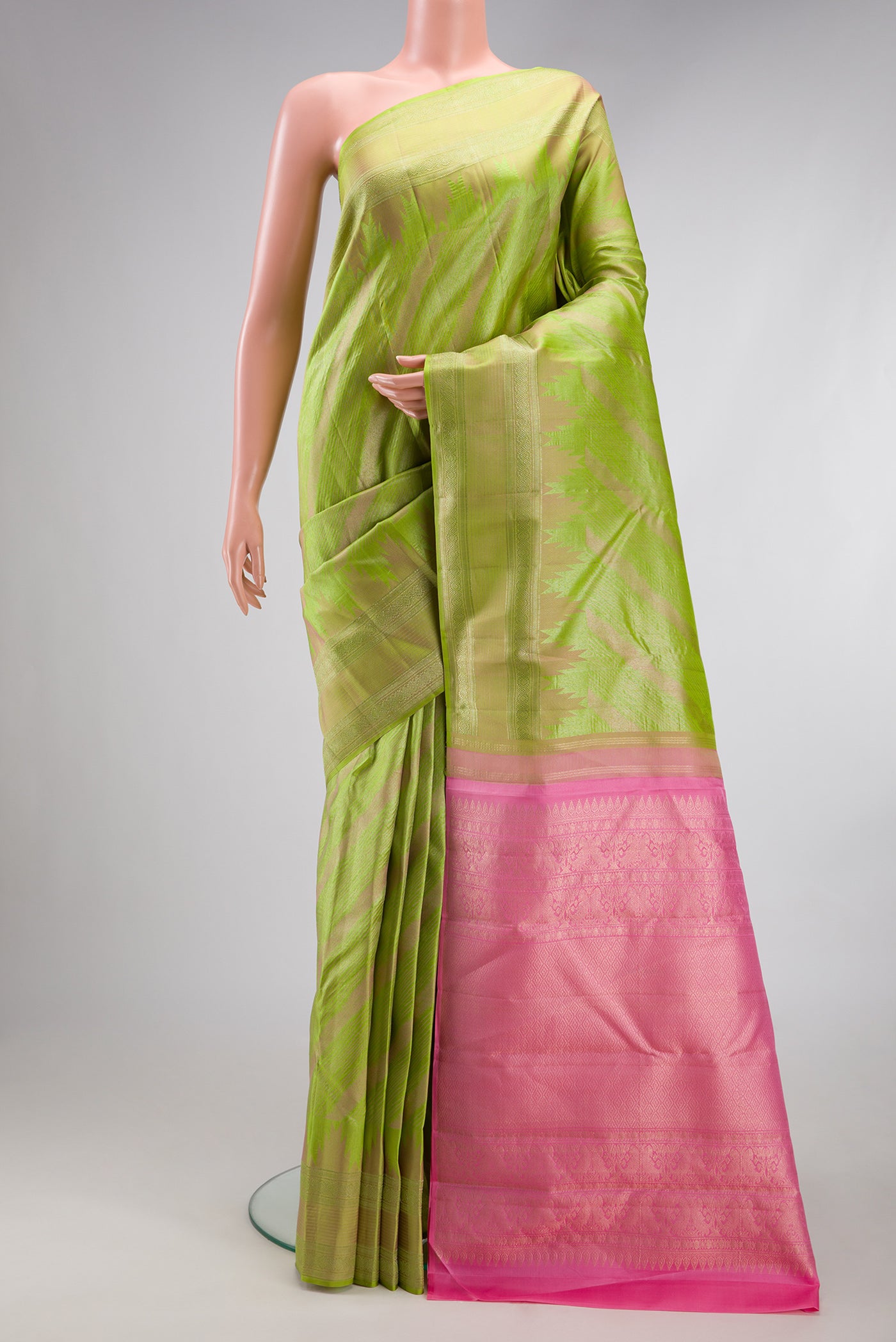 Parrot Green Dual Tone Kanjivaram Silk Saree with Stripes on the body and Fancy Border.  displayed on a mannequin