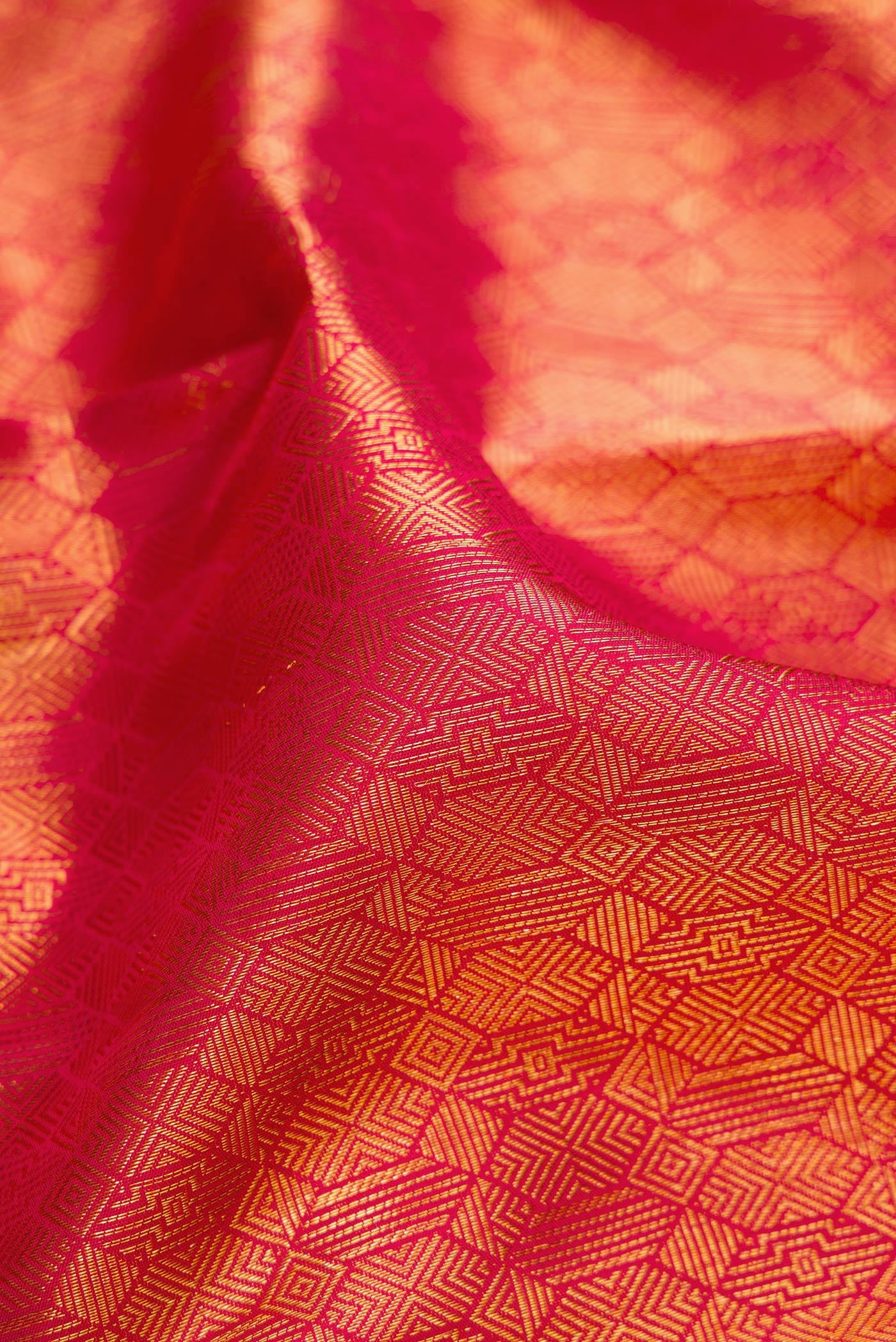 Close up of Pink Kanchipuram Silk Saree with Zari Brocade on the body and Zari Border.  displaying folds