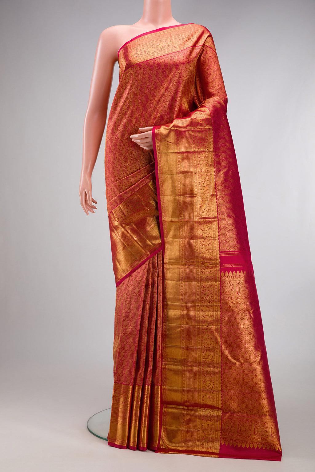 Pink Kanchipuram Silk Saree with Zari Brocade on the body and Zari Border.  displayed on a mannequin