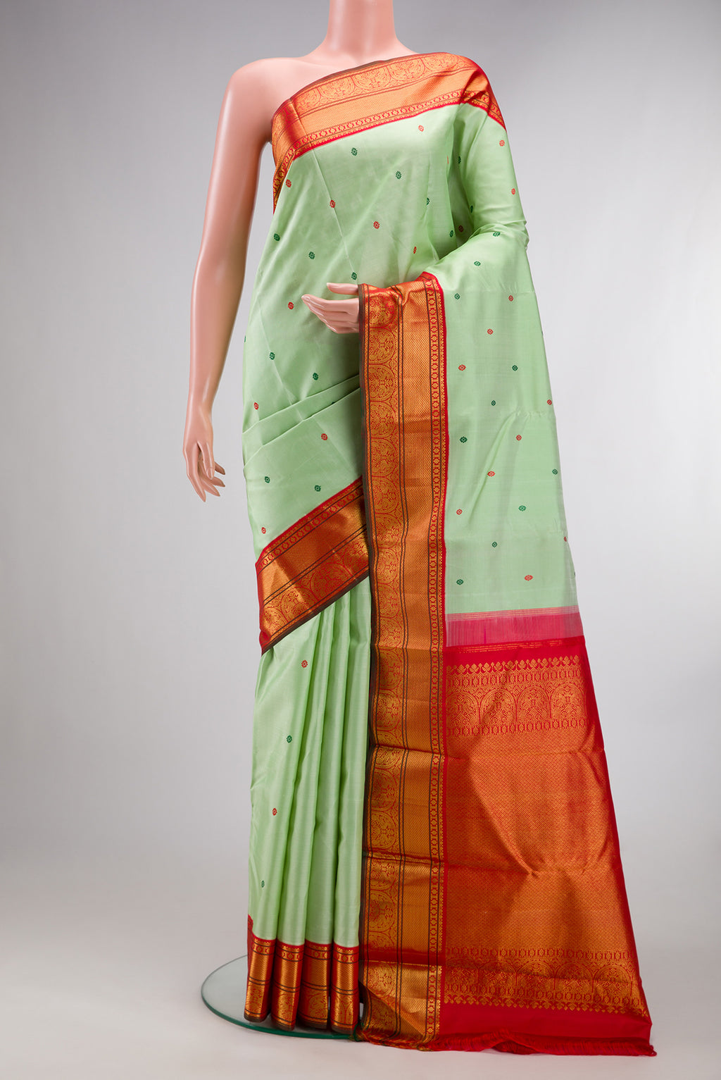 Pure Silk Pure Zari Pista Green Dual Tone Kanchipuram Saree with Thread Butta on the body and Zari Border.  displayed on a mannequin