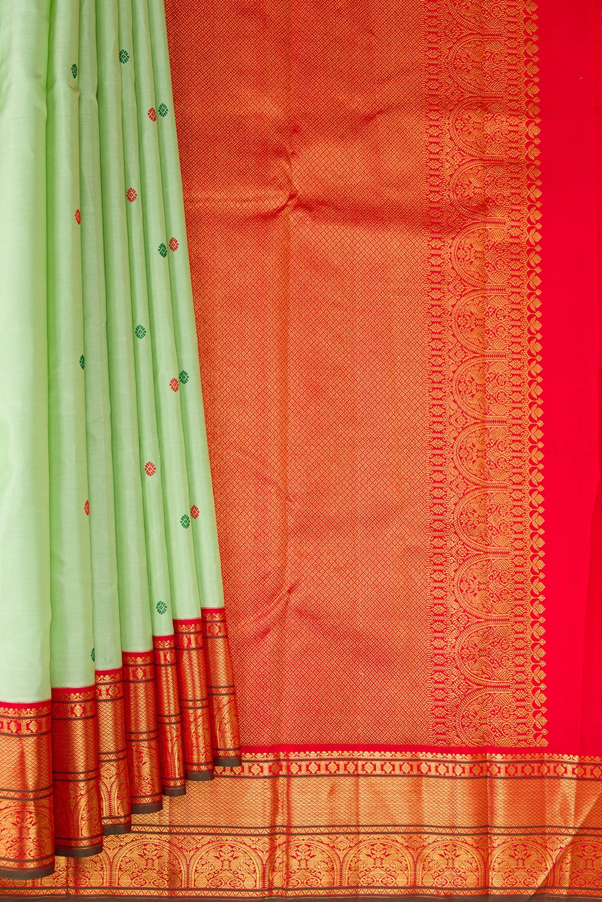 Pleats and pallu of Pure Silk Pure Zari Pista Green Dual Tone Kanchipuram Saree with Thread Butta on the body and Zari Border. 