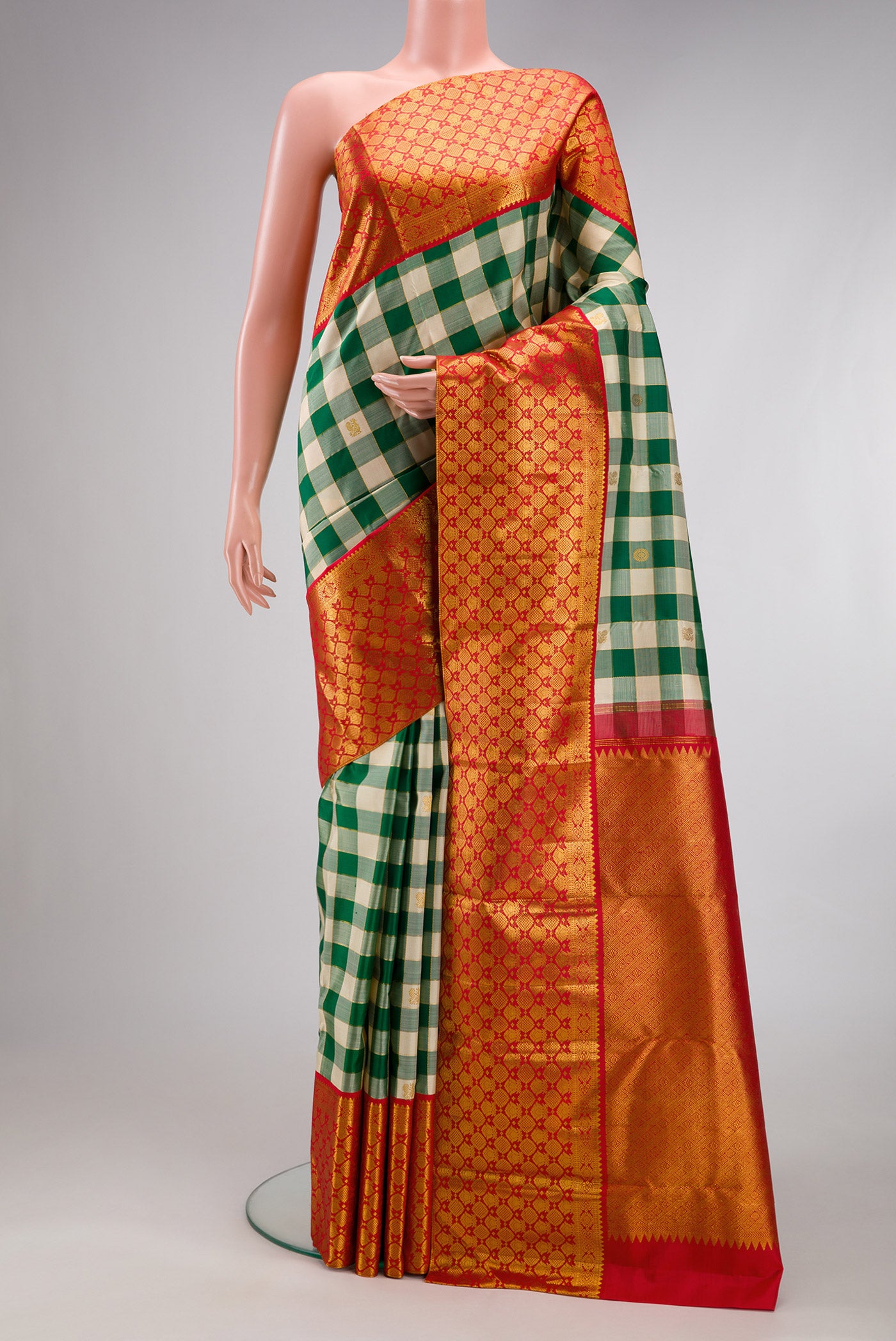 Green Kanchipuram Silk Saree with Checked design on the body and Zari Border.  displayed on a mannequin