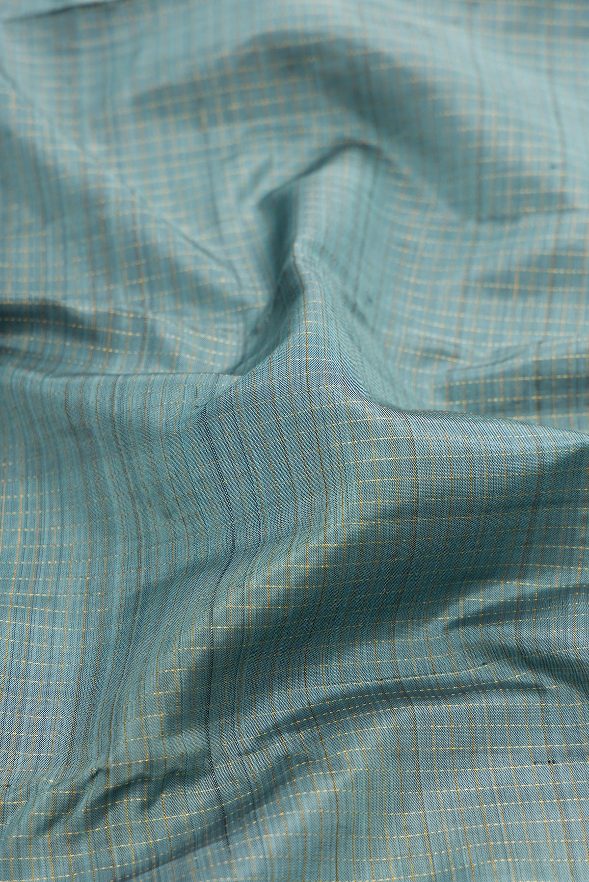 Close up of Pure Silk Grey Dual Tone Kanjivaram Saree with Checked design on the body and Zari Border.  displaying folds