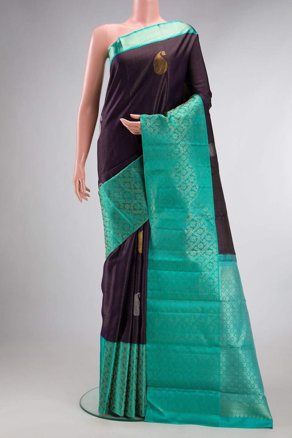 Pure Silk Purple Kanchipuram Saree with Zari Butta on the body and Fancy Border.  displayed on a mannequin