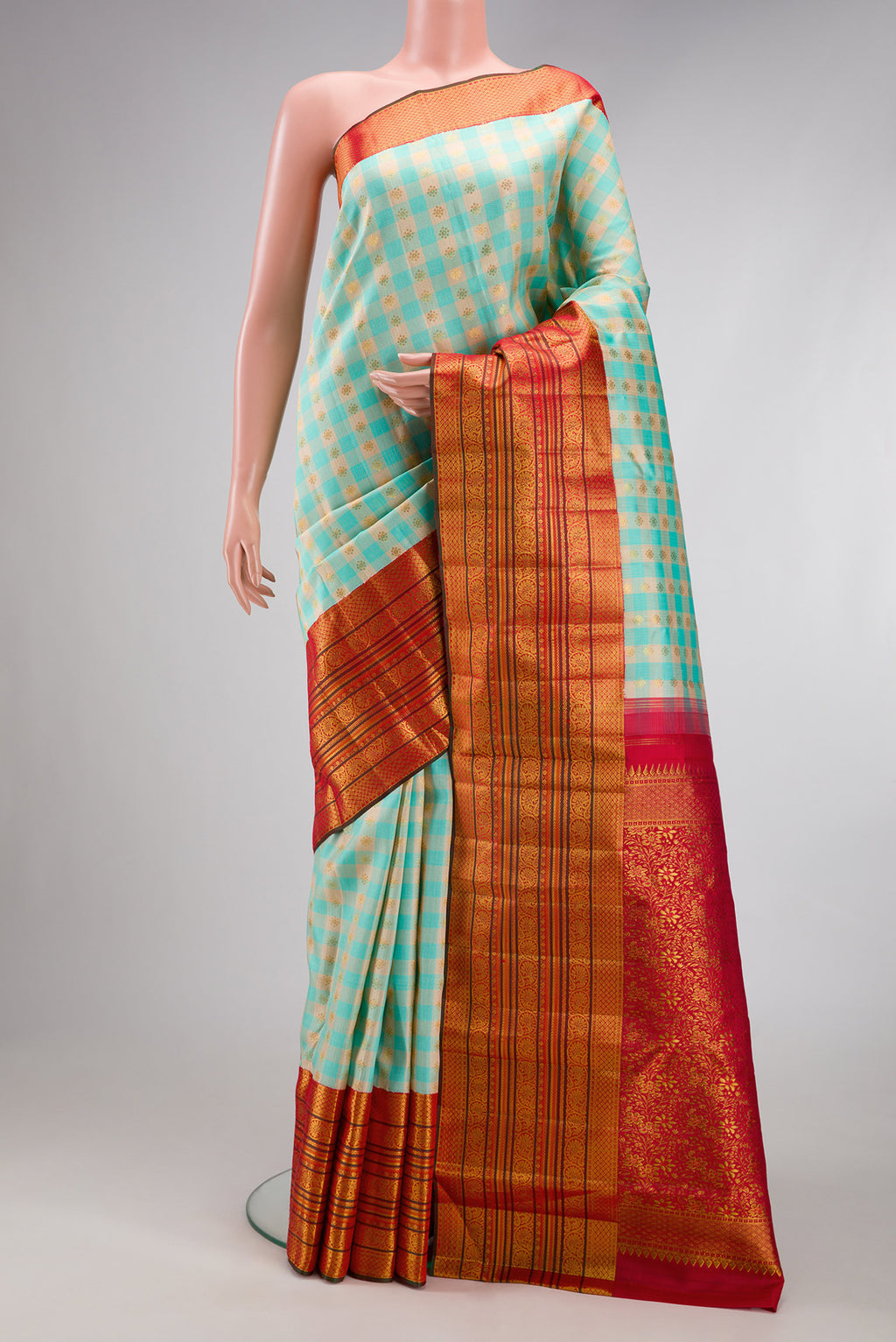 Sky Blue Kanchipuram Silk Saree with Checked design on the body and Zari Border.  displayed on a mannequin