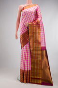 Multi Color Kanchipuram Silk Saree with Checked design on the body and Fancy Border.  displayed on a mannequin