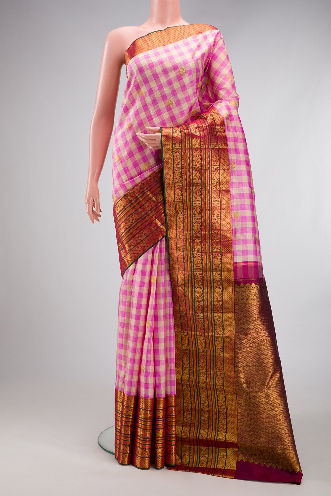 Multi Color Kanchipuram Silk Saree with Checked design on the body and Fancy Border.  displayed on a mannequin