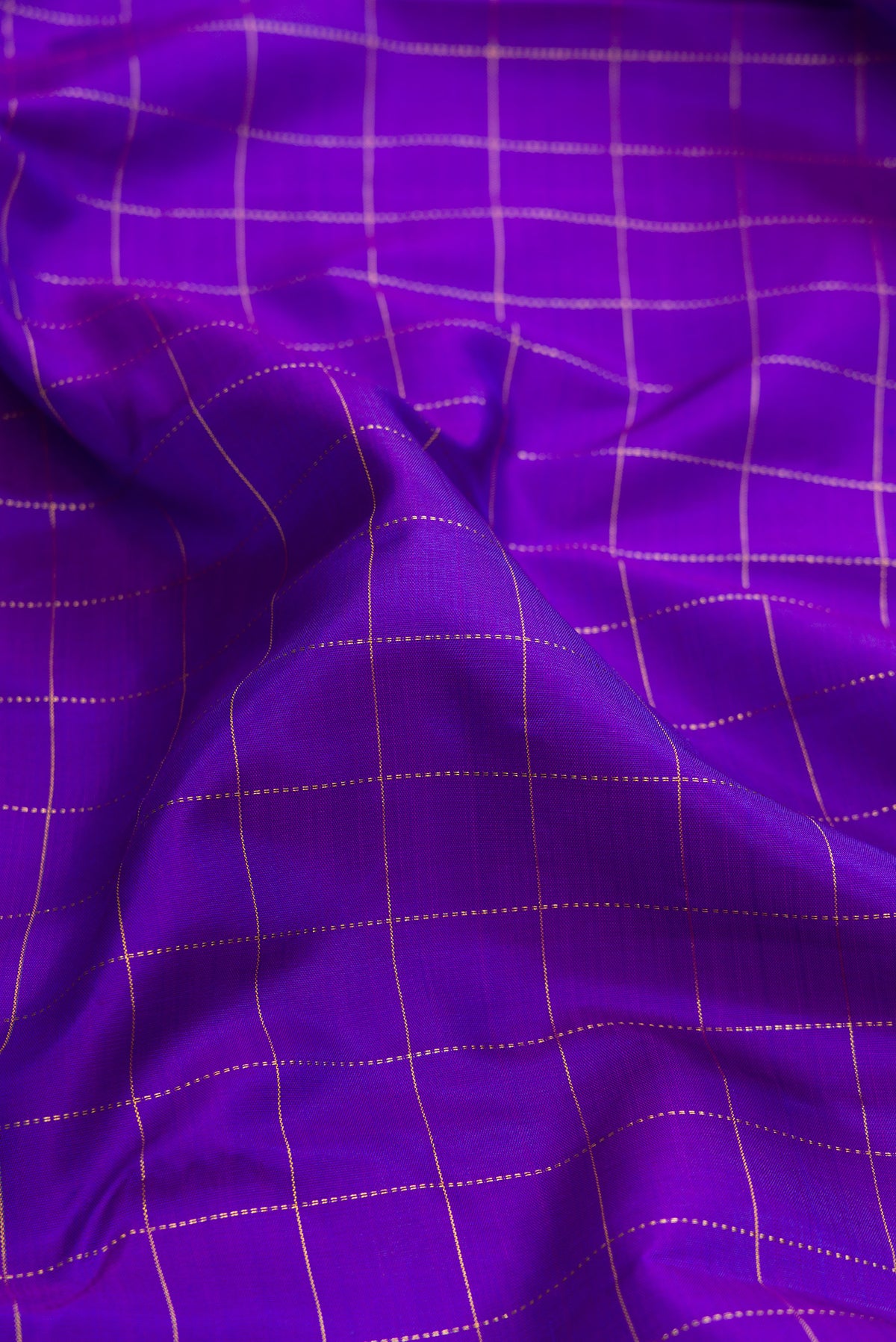 Close up of Pure Silk Violet Dual Tone Kanjivaram Saree with Checked design on the body and Zari Border.  displaying folds