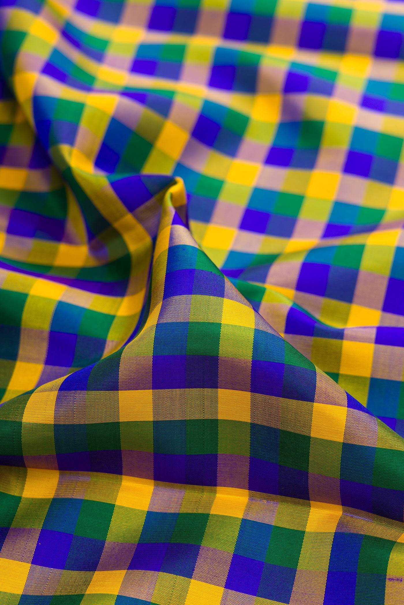 Close up of Multi Color Kanjivaram Silk Saree with Checked design on the body and Zari Border.  displaying folds