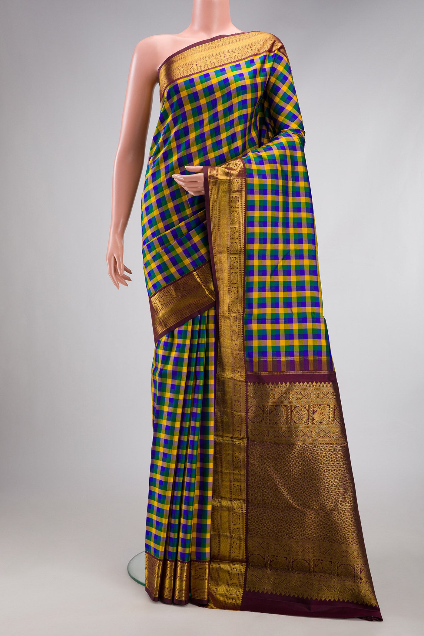 Multi Color Kanjivaram Silk Saree with Checked design on the body and Zari Border.  displayed on a mannequin