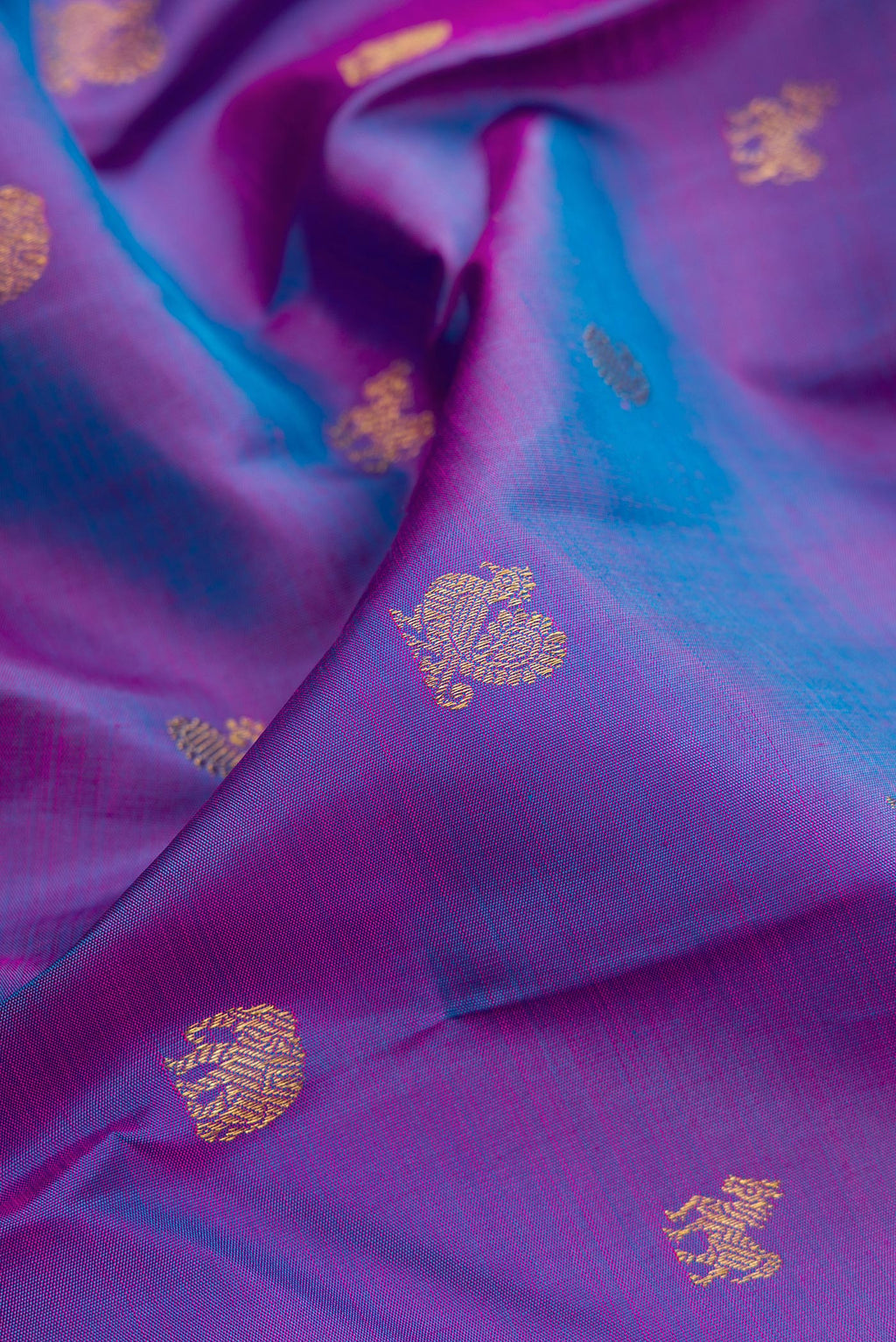 Close up of Purple Dual Tone Kanchipuram Silk Saree with Zari Butta on the body and Zari Border.  displaying folds