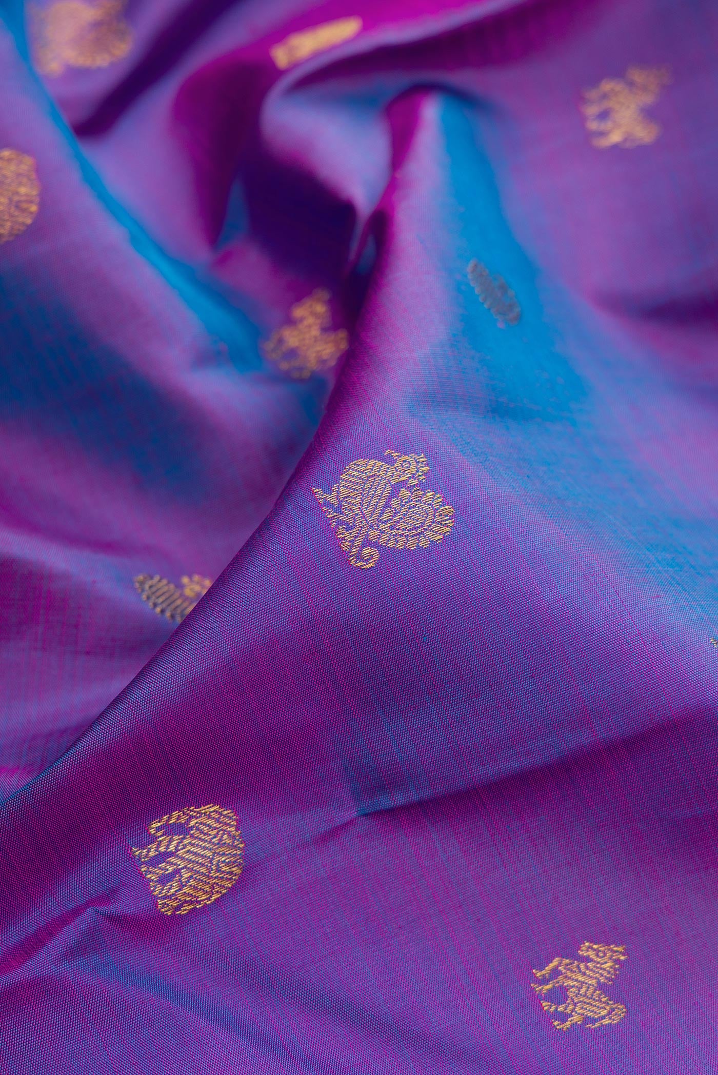 Close up of Purple Dual Tone Kanchipuram Silk Saree with Zari Butta on the body and Zari Border.  displaying folds