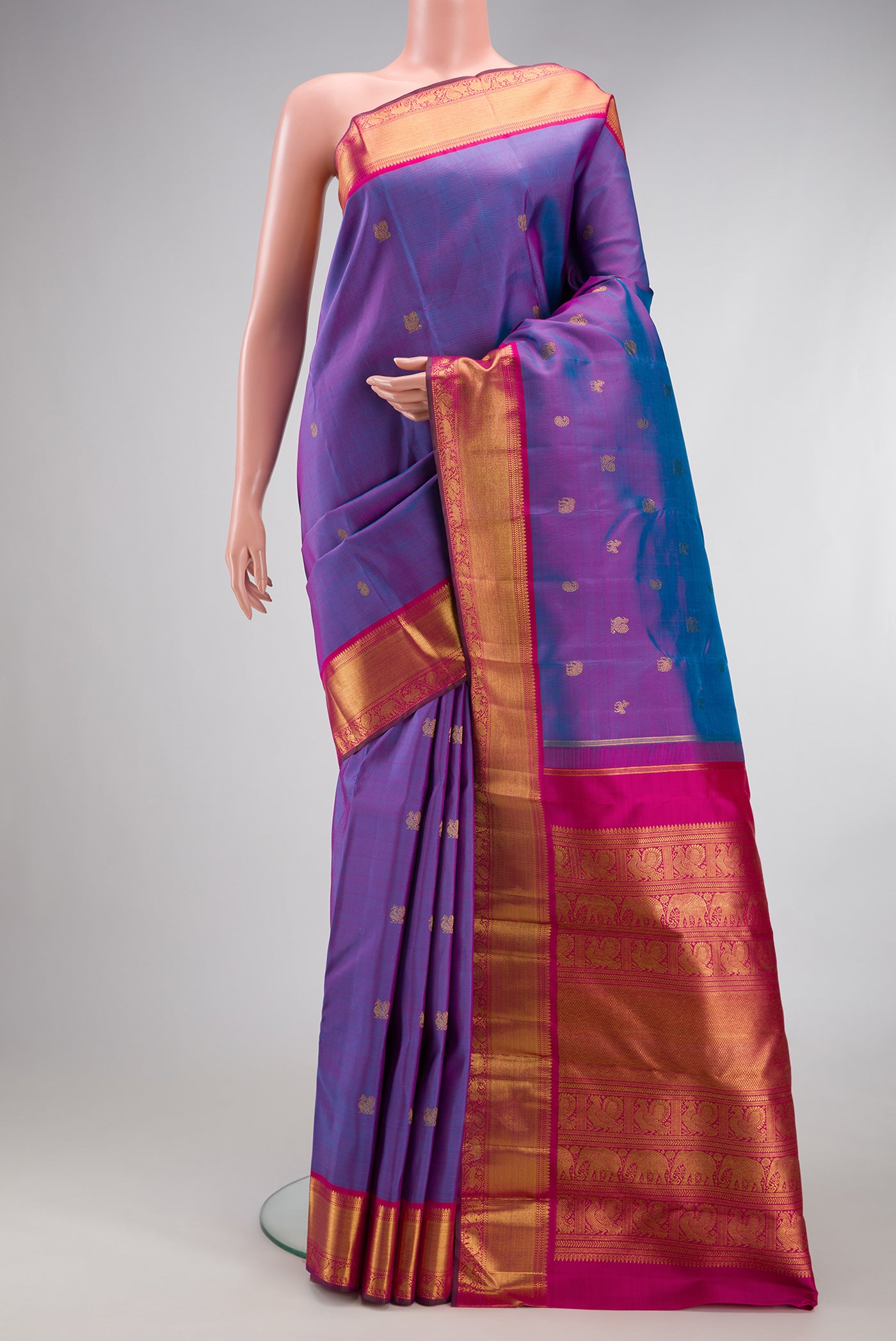Purple Dual Tone Kanchipuram Silk Saree with Zari Butta on the body and Zari Border.  displayed on a mannequin