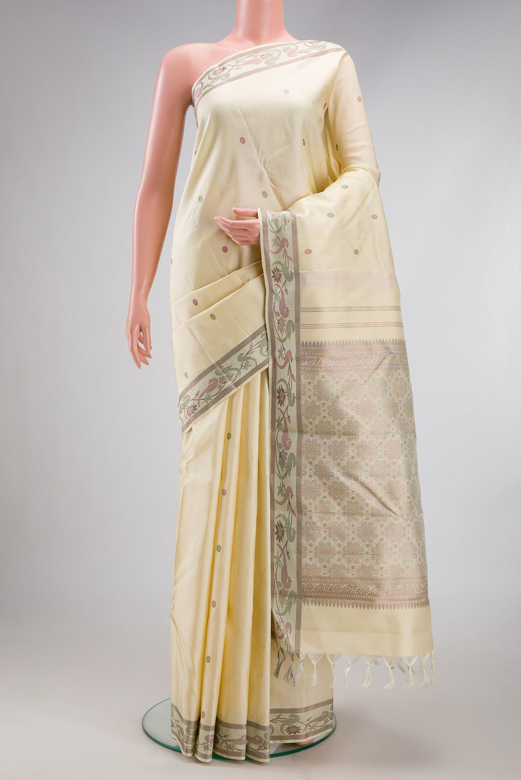 Cream Kanjivaram Silk Saree with Thread Butta on the body and Fancy Border.  displayed on a mannequin