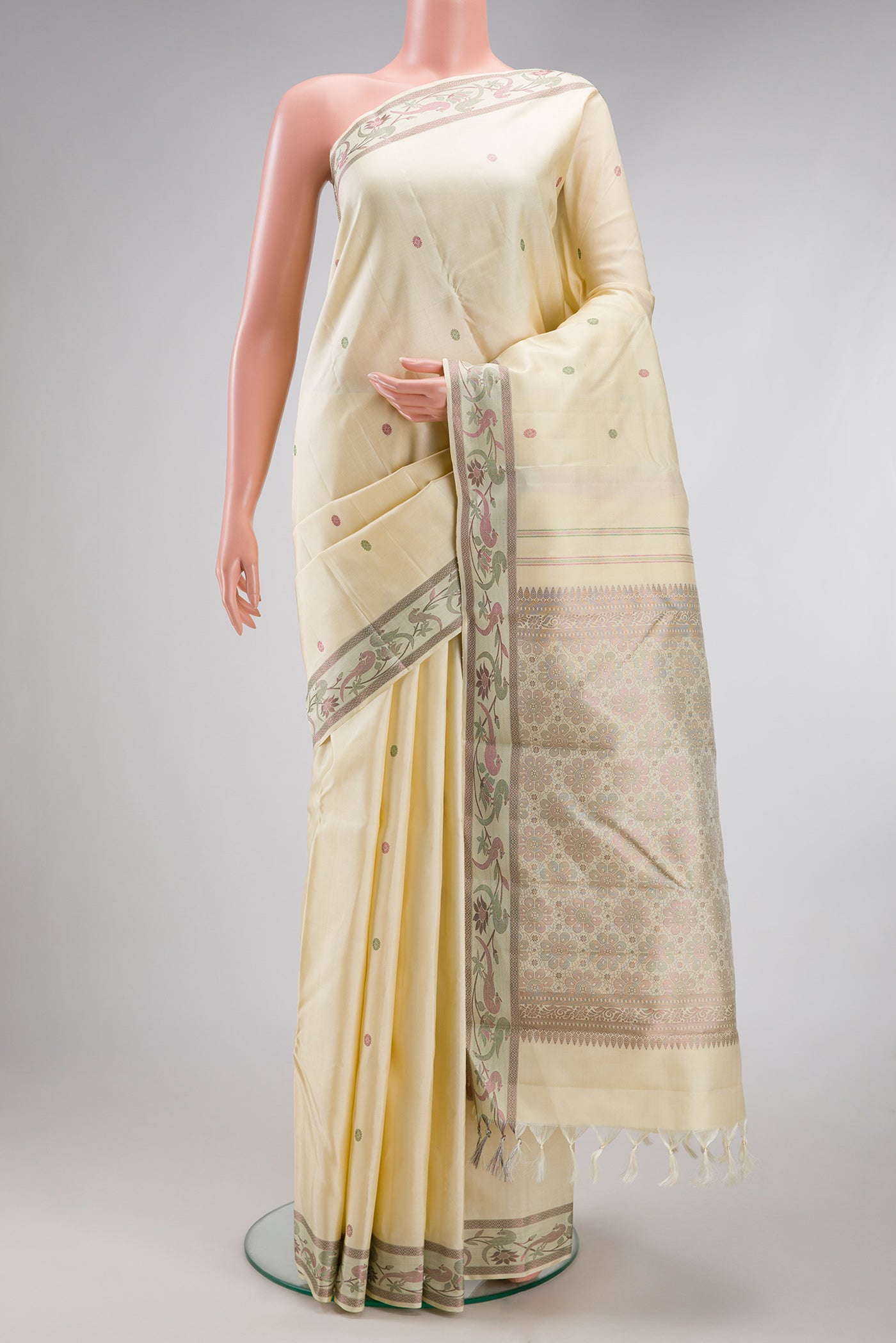 Cream Kanjivaram Silk Saree with Thread Butta on the body and Fancy Border.  displayed on a mannequin