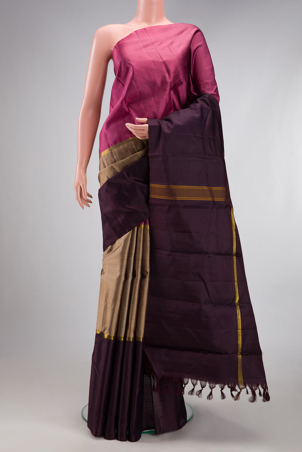 Pure Silk Pure Zari Dark Beige Kanjivaram Saree with Plain Body and Ganga Jamuna Border.  displayed on a mannequin
