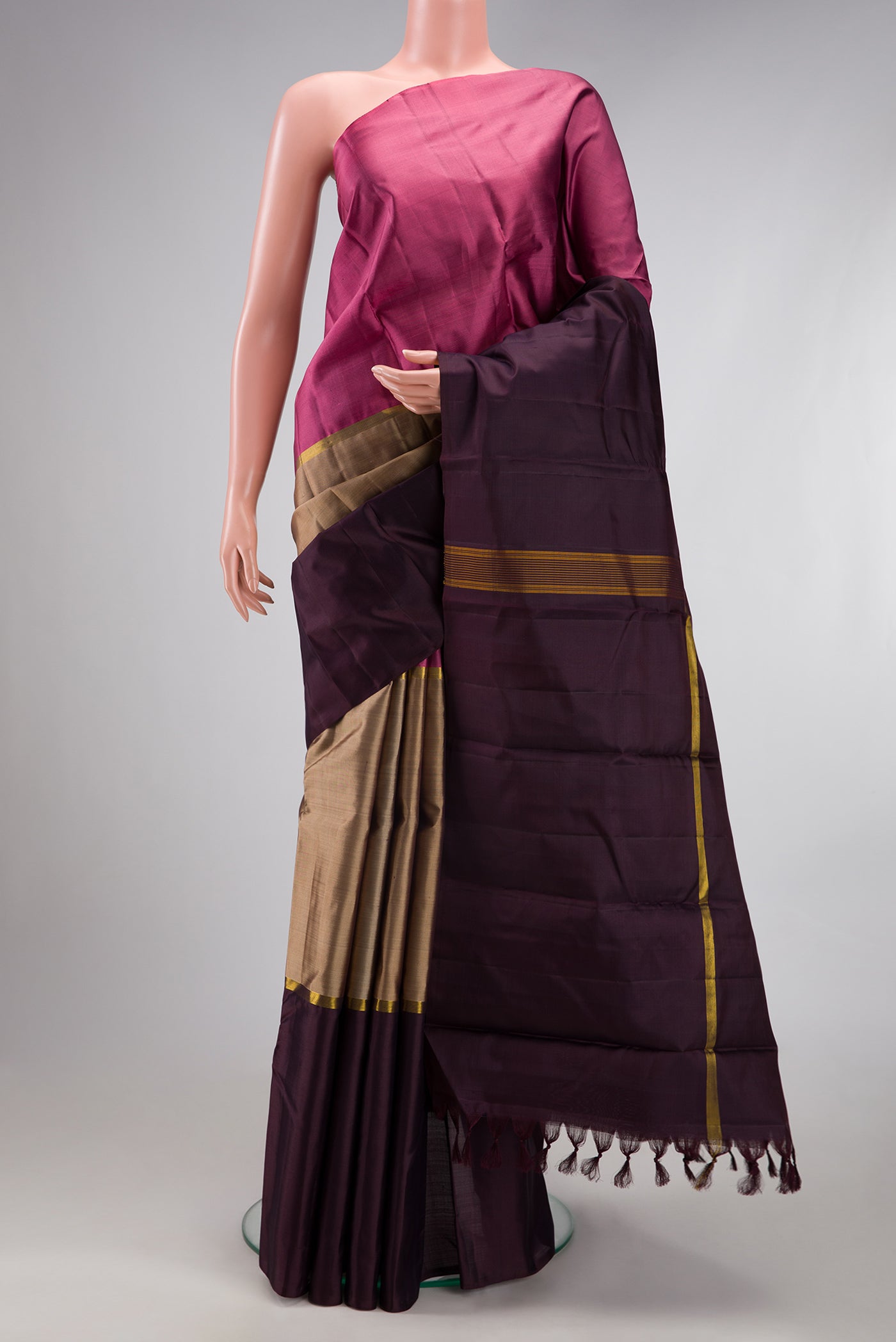 Pure Silk Pure Zari Dark Beige Kanjivaram Saree with Plain Body and Ganga Jamuna Border.  displayed on a mannequin