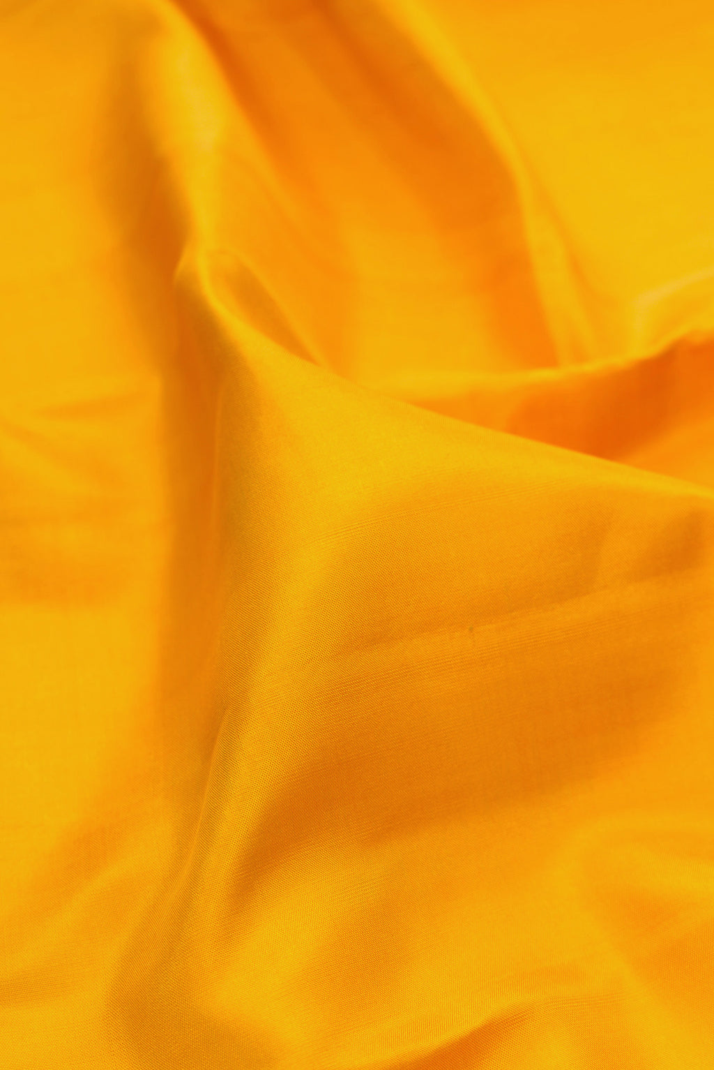 Close up of Yellow Kanjivaram Silk Saree with Plain Body and Without Border.  displaying folds