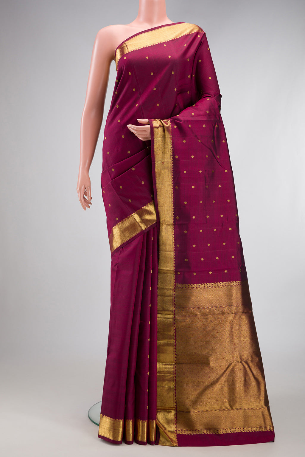 Pure Silk Pure Zari Maroon Dual Tone Kanjivaram Saree with Zari Butta on the body and Zari Border.  displayed on a mannequin