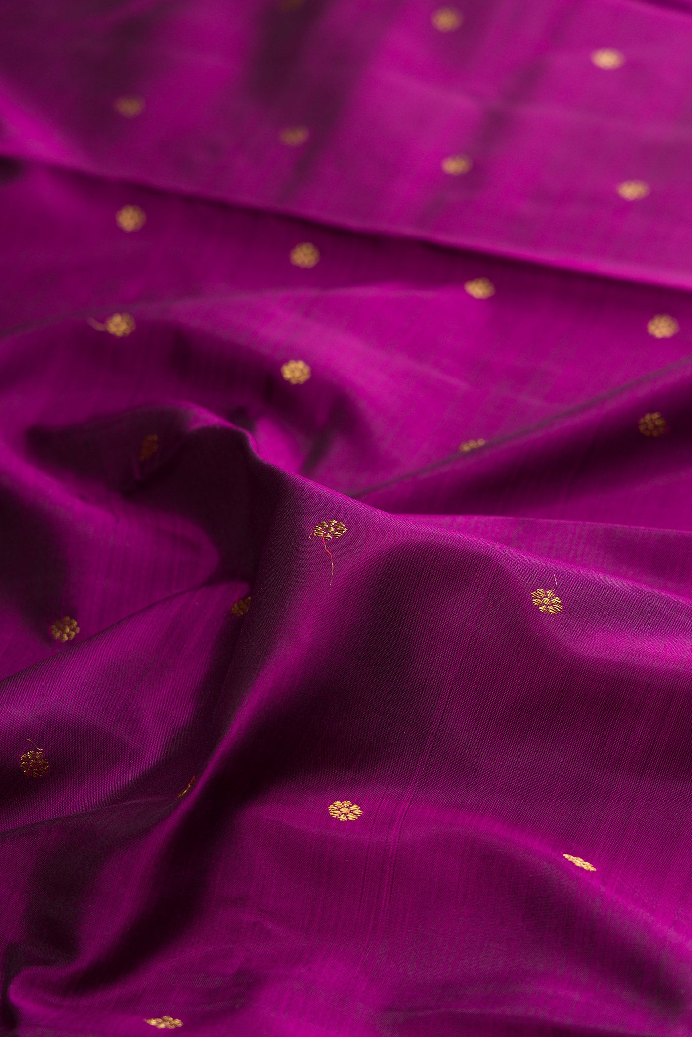 Close up of Pure Silk Pure Zari Purple Kanjivaram Saree with Zari Butta on the body and Zari Border.  displaying folds