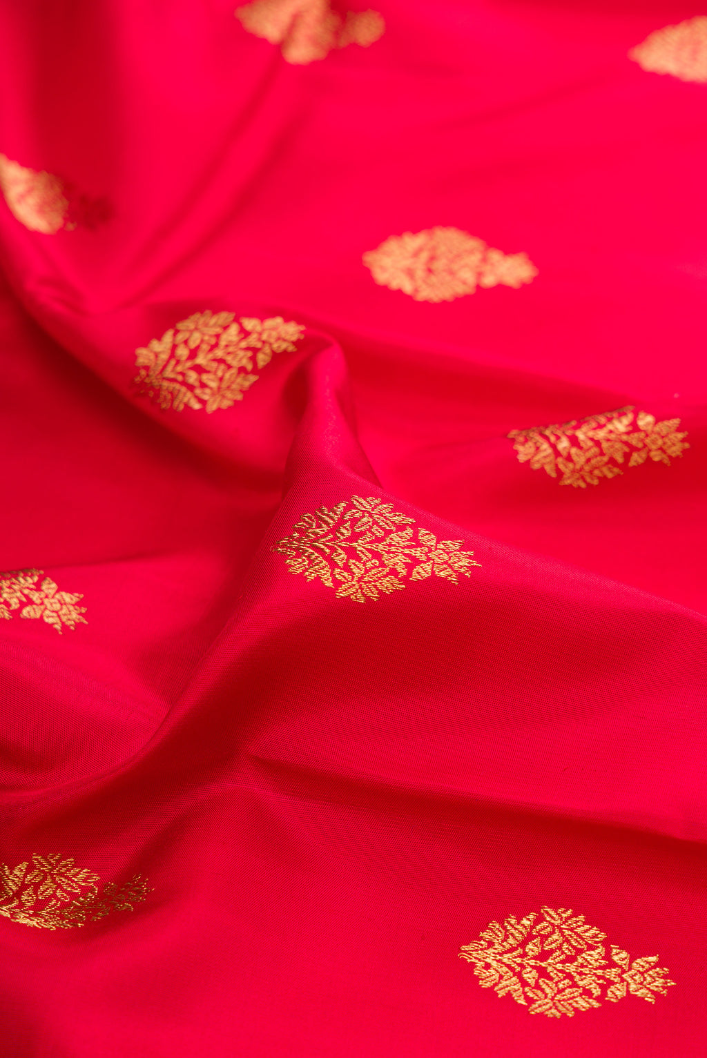Close up of Pure Silk Pure Zari Maroon Kanjivaram Saree with Zari Butta on the body and Fancy Border.  displaying folds