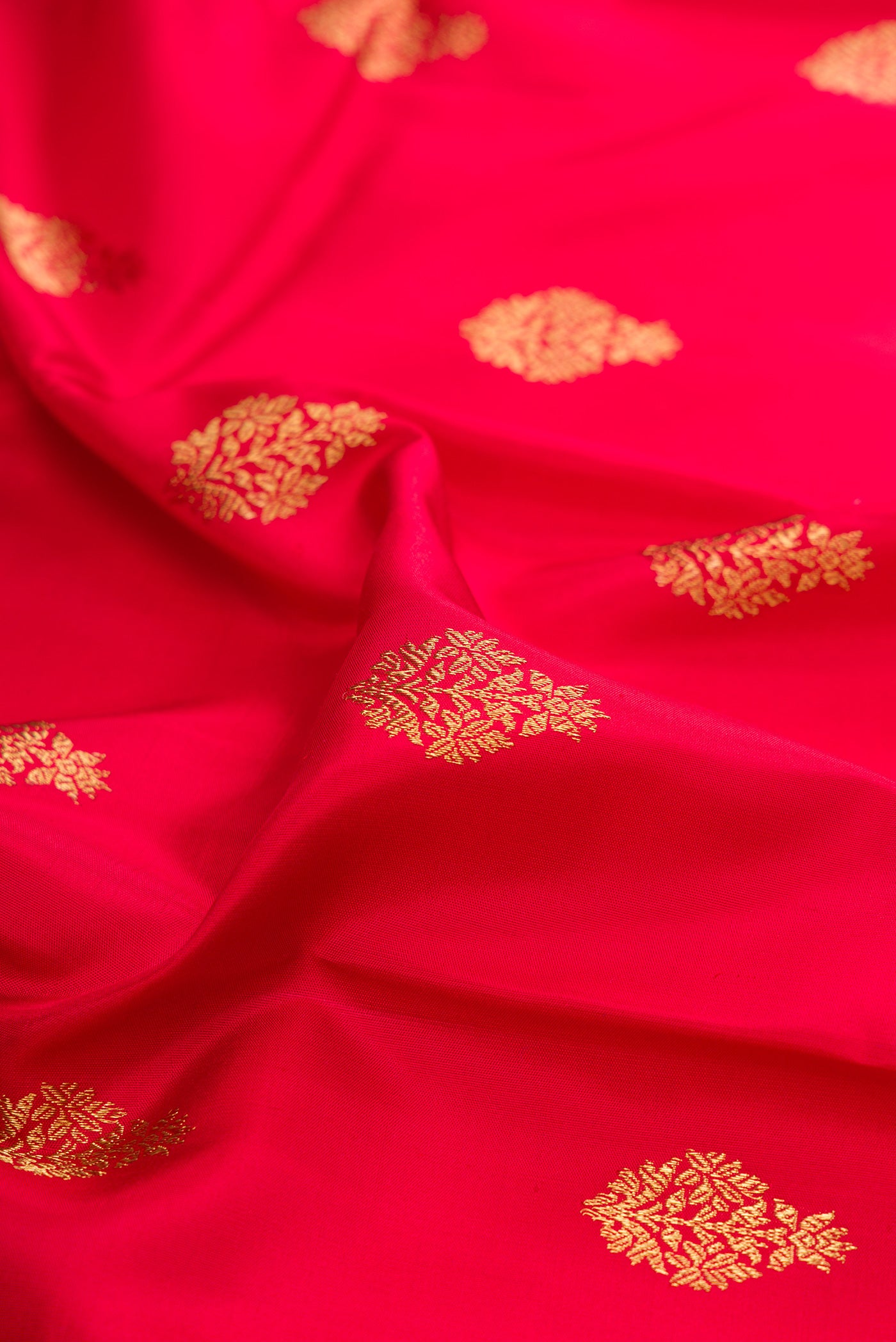 Close up of Pure Silk Pure Zari Maroon Kanjivaram Saree with Zari Butta on the body and Fancy Border.  displaying folds