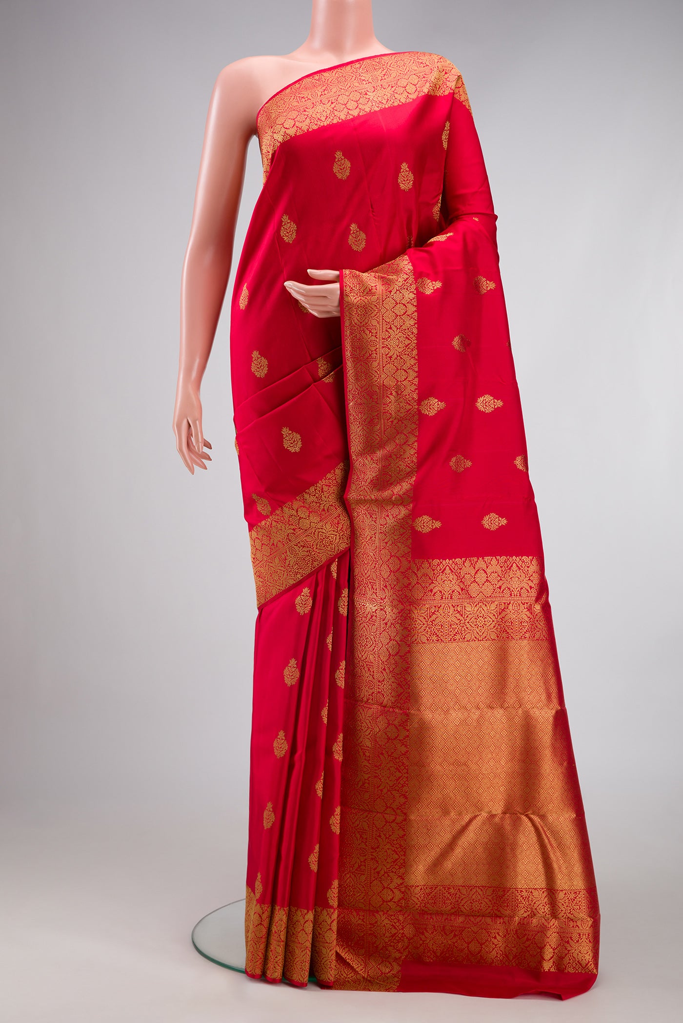 Pure Silk Pure Zari Maroon Kanjivaram Saree with Zari Butta on the body and Fancy Border.  displayed on a mannequin