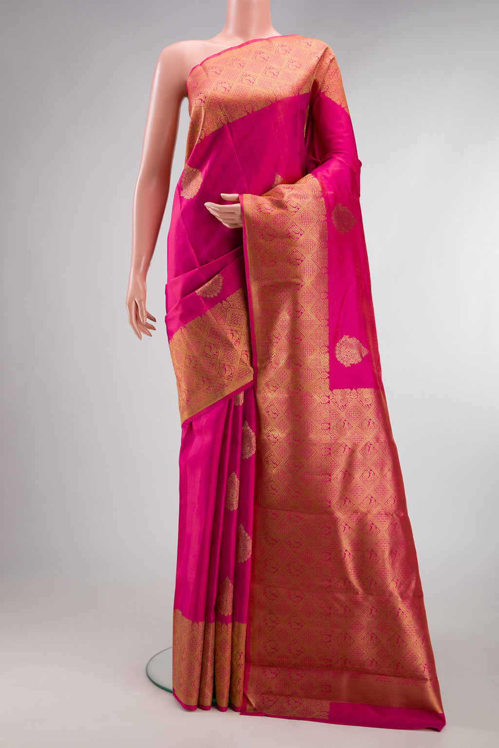 Pure Silk Pure Zari Pink Kanjivaram Saree with Zari Butta on the body and Zari Border.  displayed on a mannequin