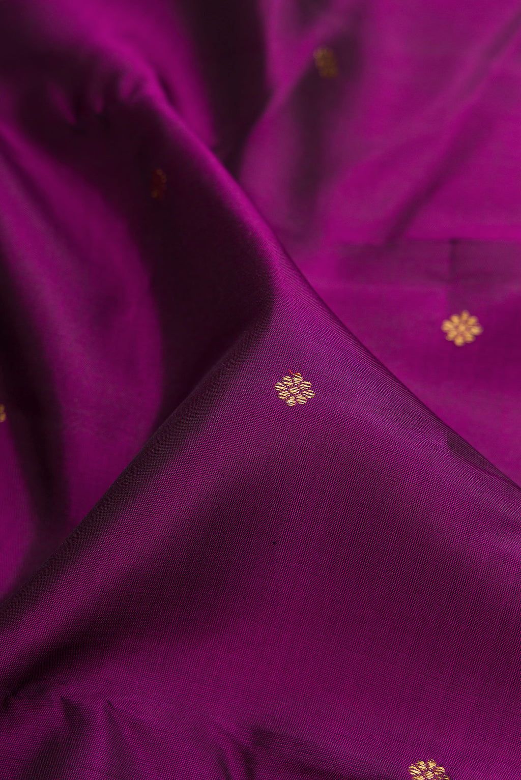 Close up of Pure Silk Pure Zari Purple Kanjivaram Saree with Zari Butta on the body and Zari Border.  displaying folds