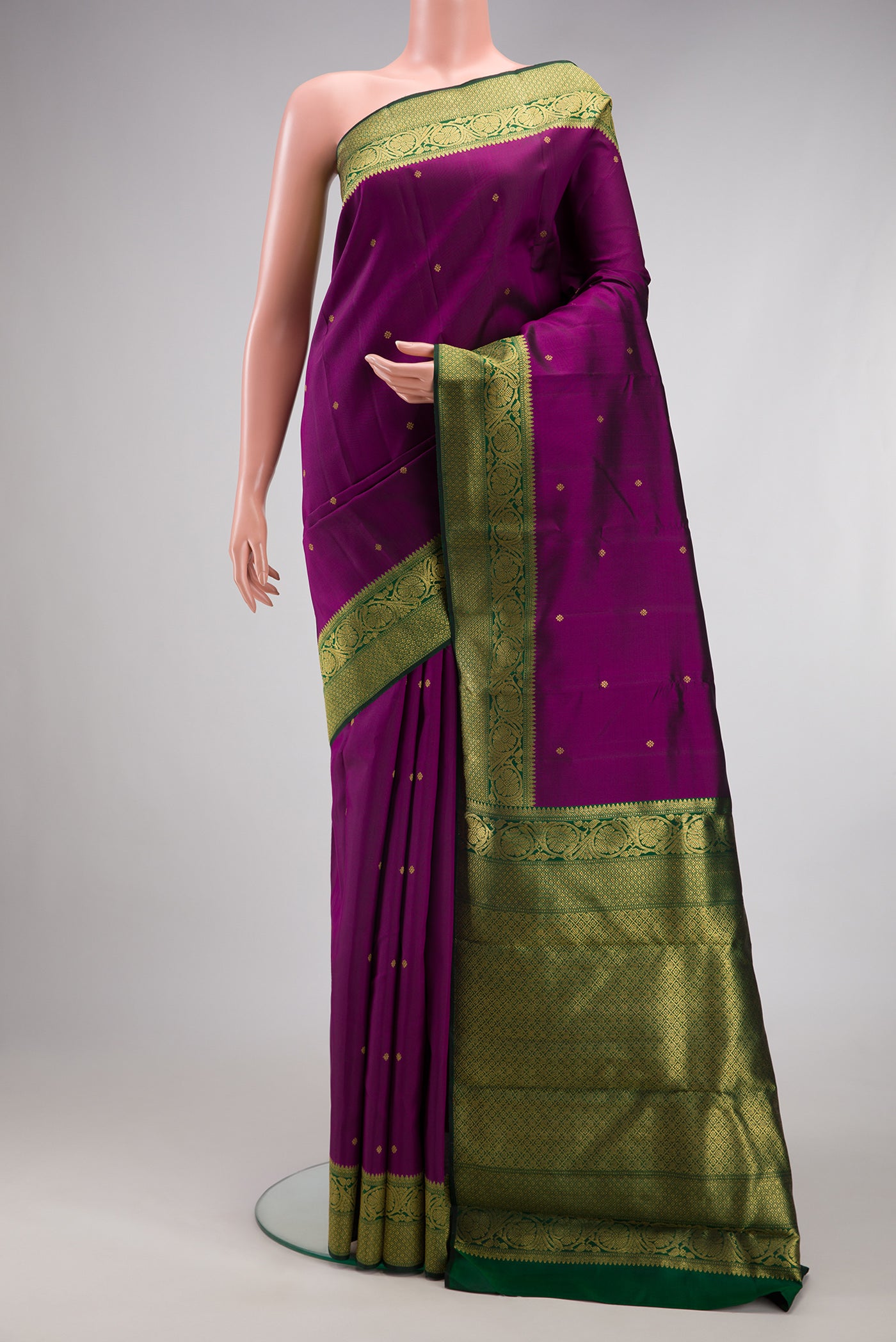 Pure Silk Pure Zari Purple Kanjivaram Saree with Zari Butta on the body and Zari Border.  displayed on a mannequin