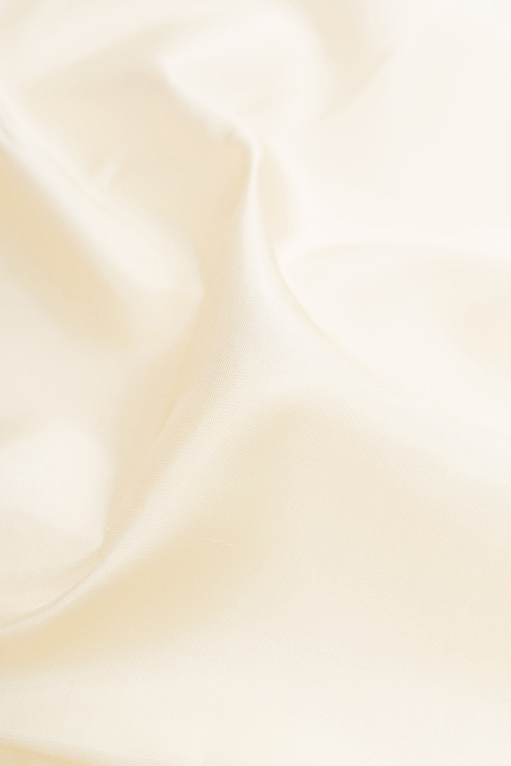 Close up of Pure Silk Pure Zari Off White Kanjivaram Saree with Plain Body and Fancy Border.  displaying folds