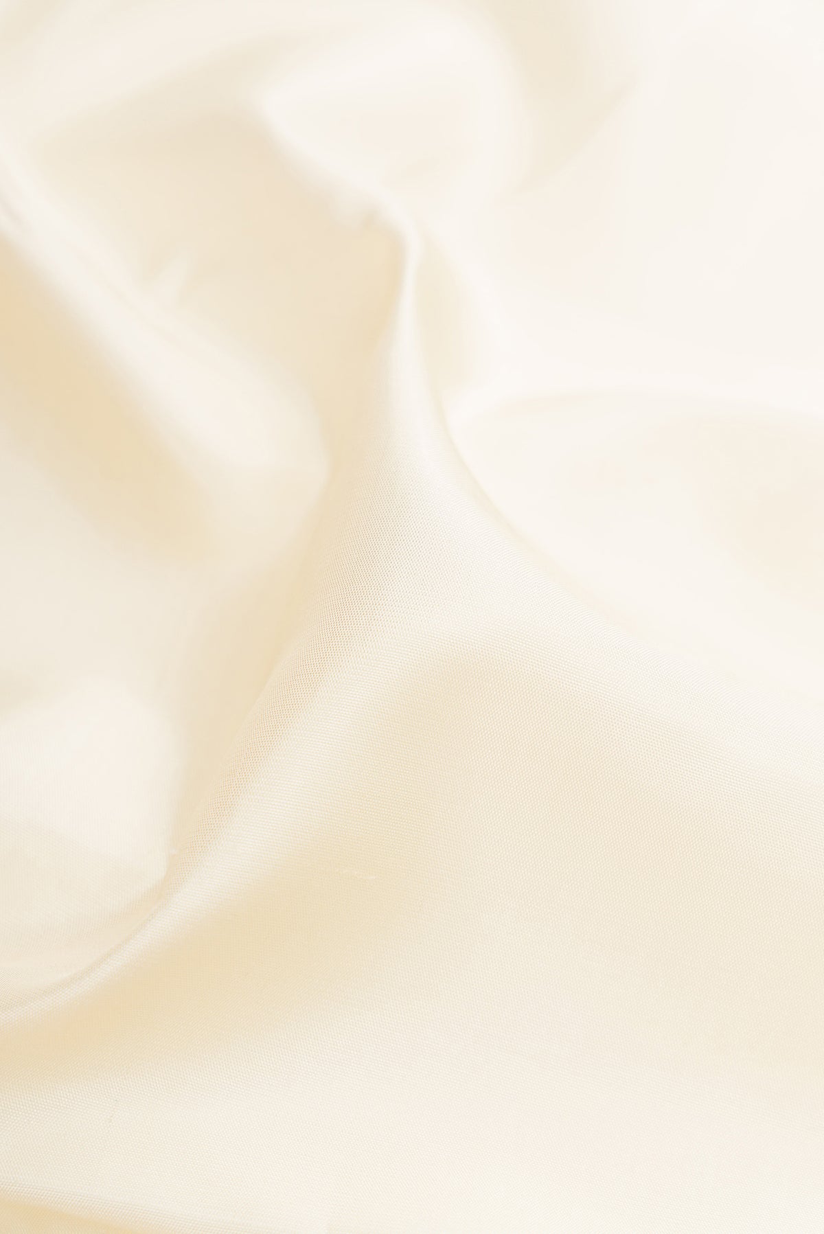 Close up of Pure Silk Pure Zari Off White Kanjivaram Saree with Plain Body and Fancy Border.  displaying folds