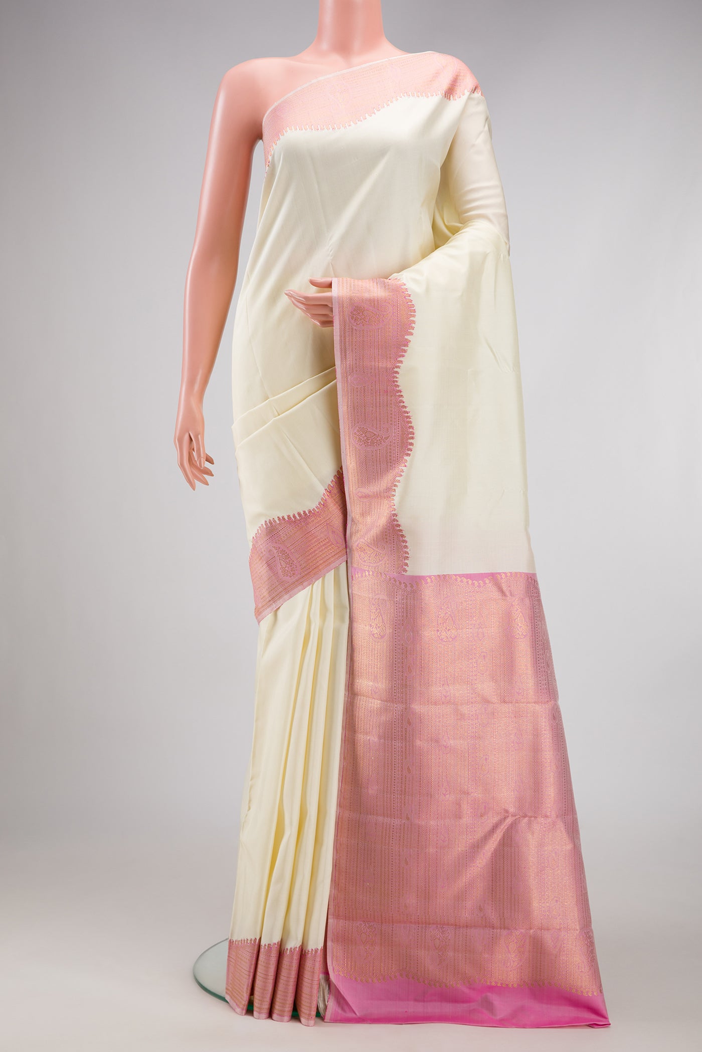 Pure Silk Pure Zari Off White Kanjivaram Saree with Plain Body and Fancy Border.  displayed on a mannequin