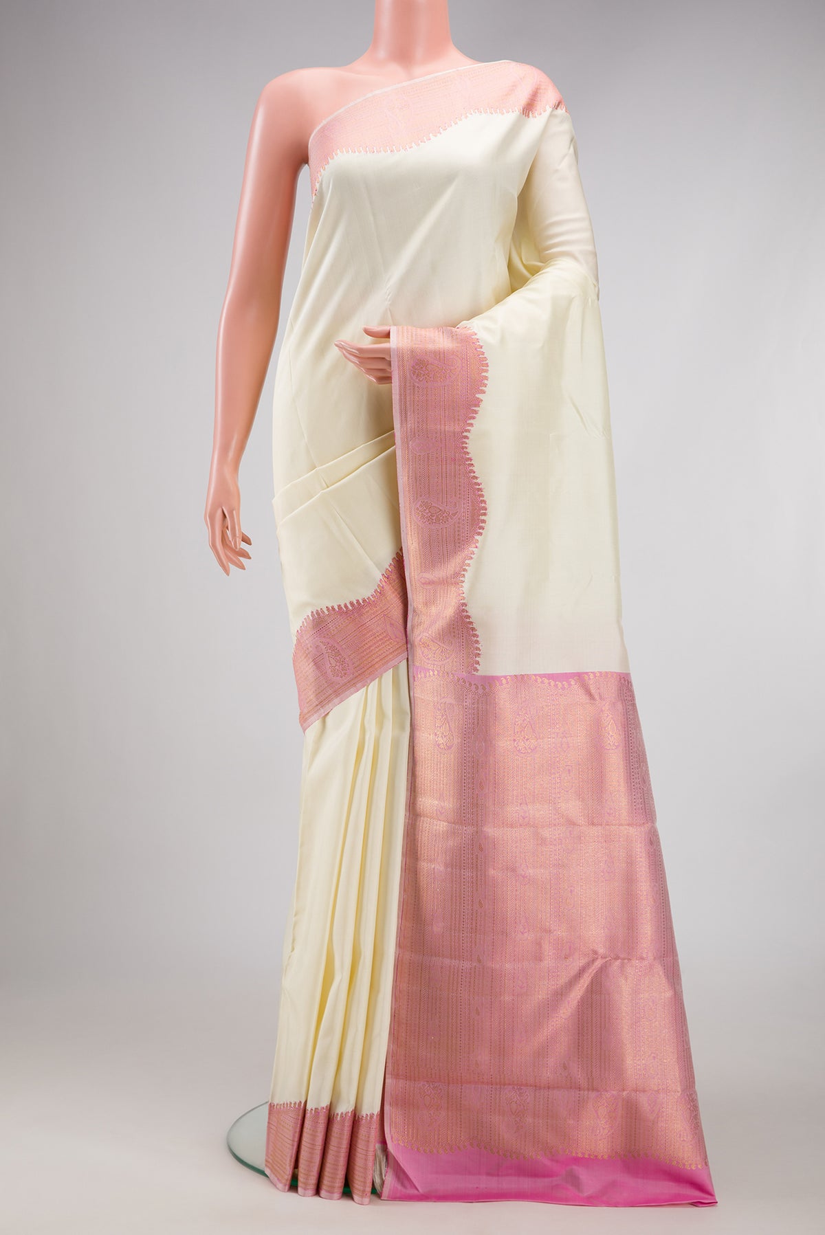 Pure Silk Pure Zari Off White Kanjivaram Saree with Plain Body and Fancy Border.  displayed on a mannequin