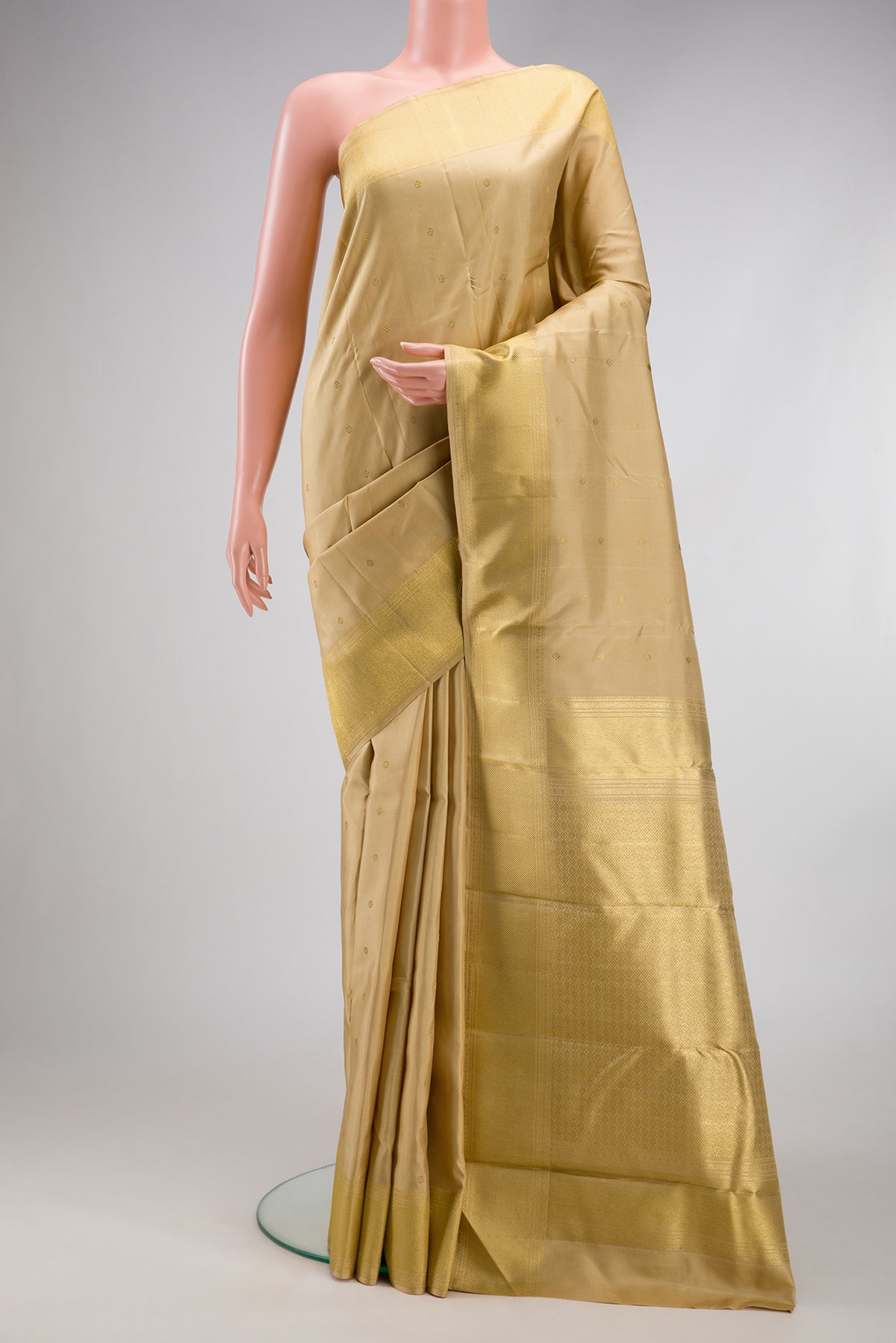Pure Silk Pure Zari Dark Beige Kanjivaram Saree with Zari Butta on the body and Zari Border.  displayed on a mannequin