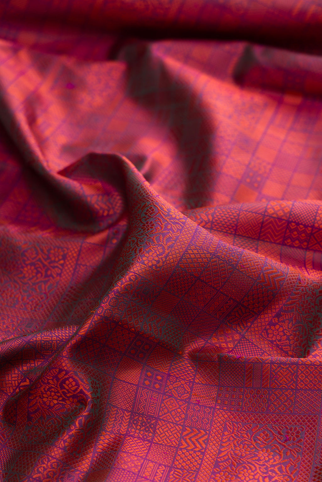 Close up of Pure Silk Magenta Dual Tone Kanjivaram Saree with Jacquard design on the body and Ganga Jamuna Border.  displaying folds