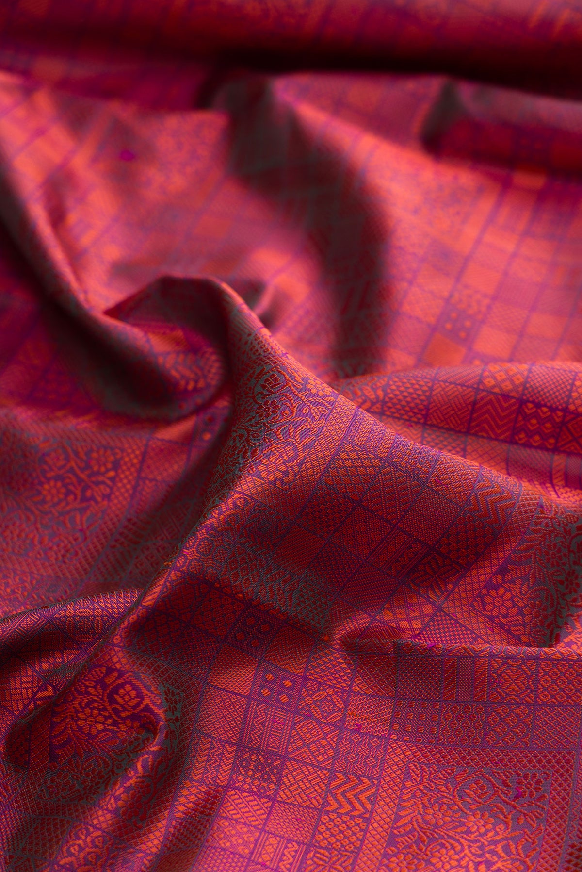 Close up of Pure Silk Magenta Dual Tone Kanjivaram Saree with Jacquard design on the body and Ganga Jamuna Border.  displaying folds