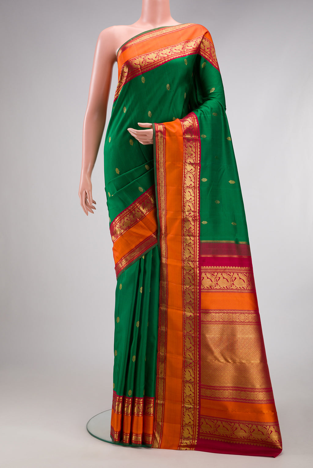 Pure Silk Pure Zari Green Kanjivaram Saree with Zari Butta on the body and Zari Border.  displayed on a mannequin