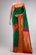 Pure Silk Pure Zari Green Kanjivaram Saree with Zari Butta on the body and Zari Border.  displayed on a mannequin