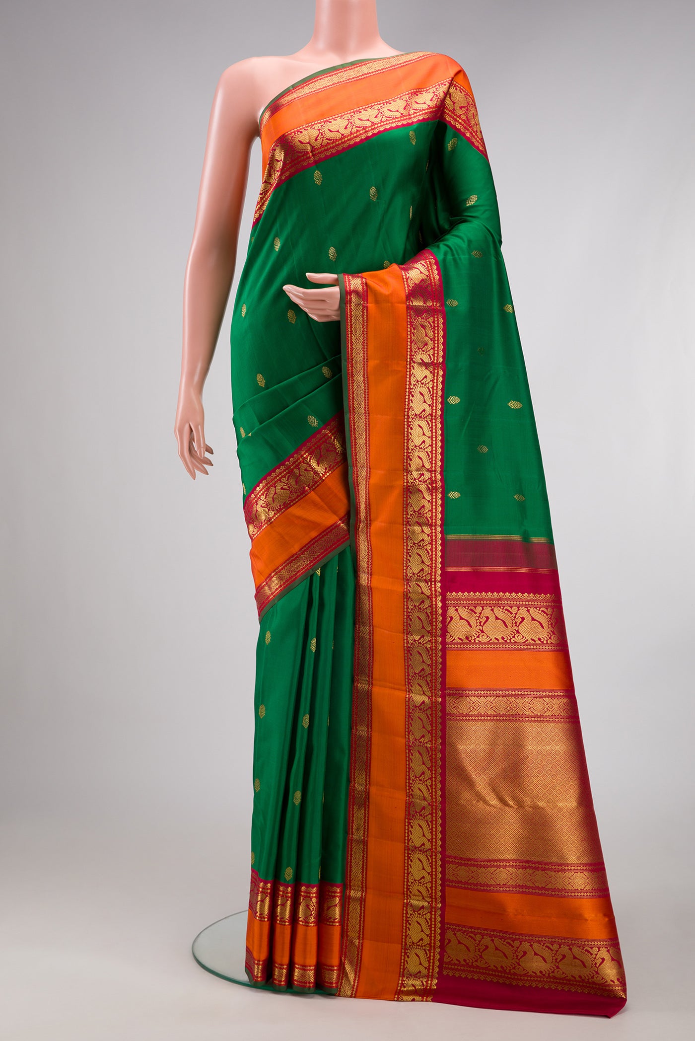 Pure Silk Pure Zari Green Kanjivaram Saree with Zari Butta on the body and Zari Border.  displayed on a mannequin