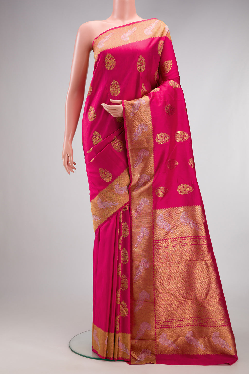 Pure Silk Pure Zari Pink Kanjivaram Saree with Zari Butta on the body and Fancy Border.  displayed on a mannequin