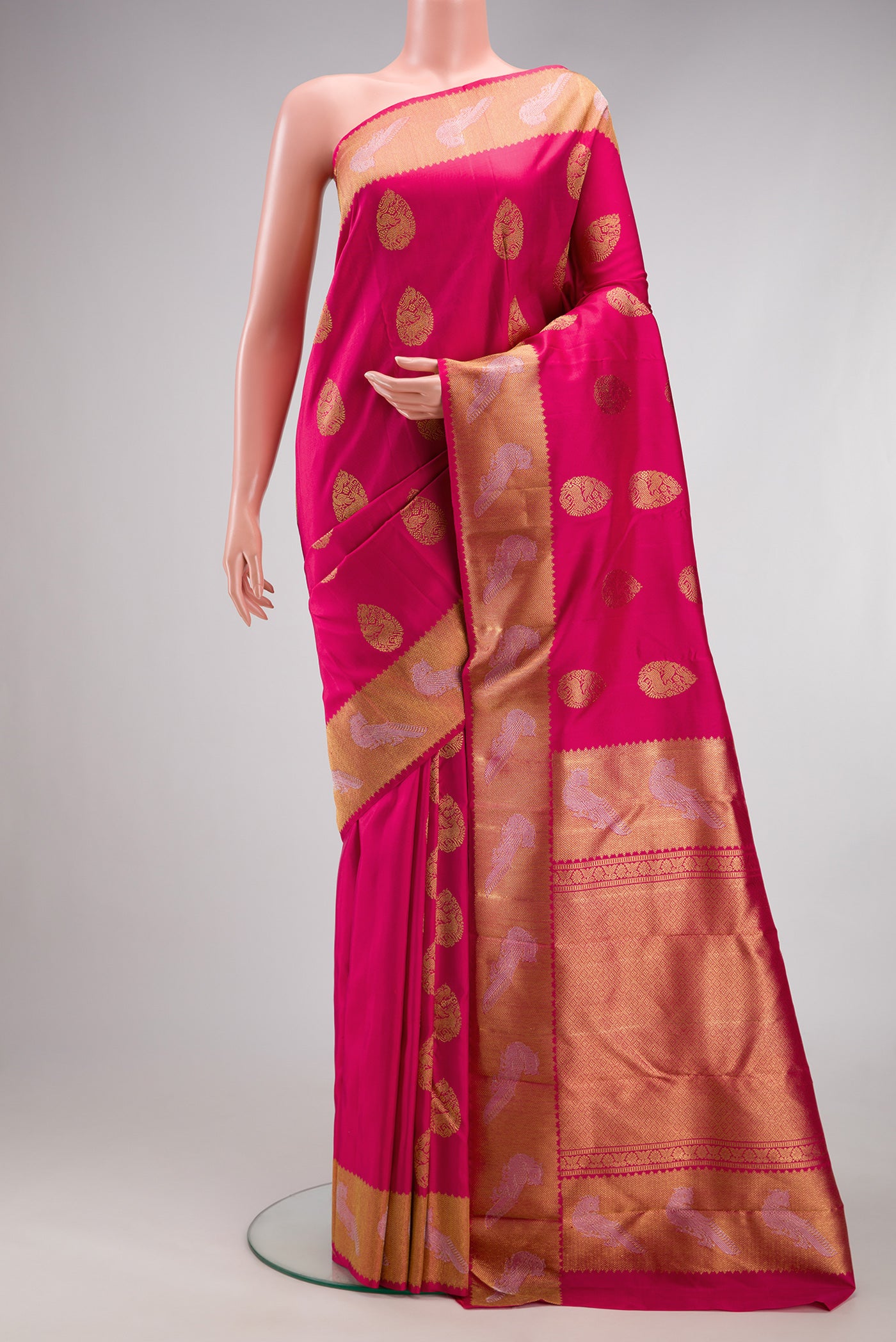 Pure Silk Pure Zari Pink Kanjivaram Saree with Zari Butta on the body and Fancy Border.  displayed on a mannequin