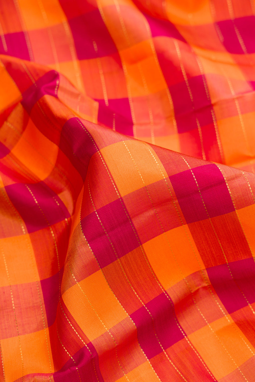 Close up of Pure Silk Pure Zari Orange and Maroon Dual Tone Kanjivaram Saree with Checked design on the body and Zari Border.  displaying folds