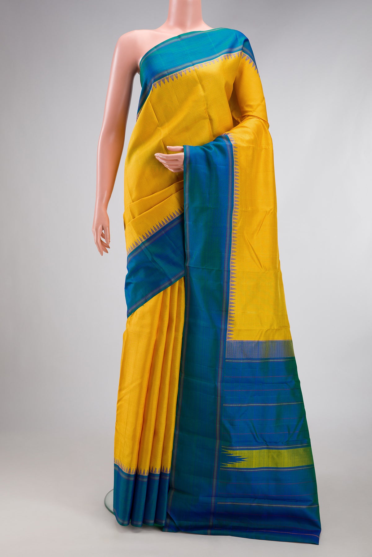 Yellow Kanjivaram Silk Saree with Checked design on the body and Temple Border.  displayed on a mannequin